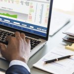 Black businessman using computer laptop